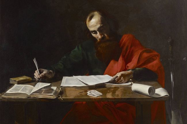 A scholar in red and green robes writing at a table